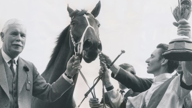 "All I know is he beat Rain Lover easily on the Saturday (in the Mackinnon) and was to meet him 12 pounds (5.4kg) better": Roy Higgins holds the 1969 Caulfield Cup trophy aloft. 