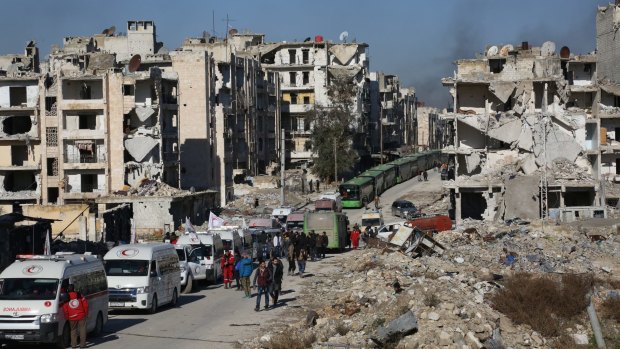 A convoy including buses and ambulances waits at a crossing point to evacuate civilians trying to flee Aleppo last week.