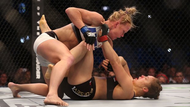 Brutal: Holly Holm takes it to previously undefeated champion Ronda Rousey in Melbourne last November.