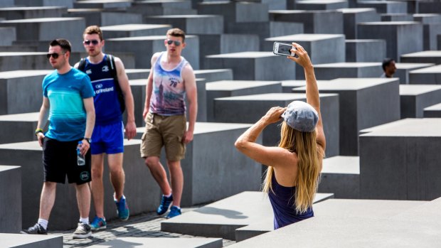 Tourists taking photos at the Holocaust Memorial in Berlin.