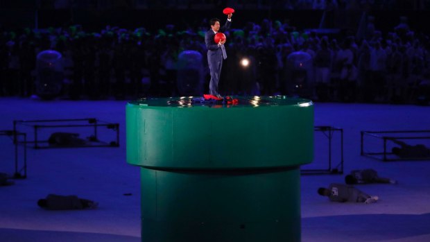 Seven has already written off $70 million of the cost broadcasting the 2020 Tokyo Olympics because it now expects much lower advertising revenue from the event. 
Japan's Prime Minister Shinzo Abe waves as he stands on Mario's giant plumbing pipe. 