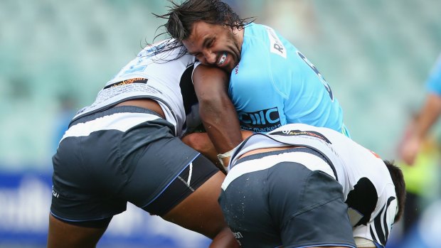 Going nowhere fast: Jacques Potgieter of the Waratahs is crunched by the Force defence.