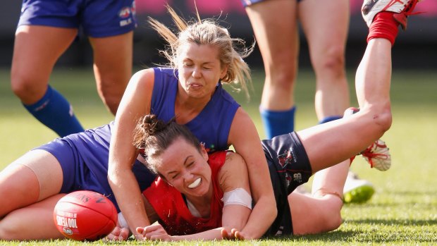Pearce is tackled during a Women's AFL exhibition match in May. 
