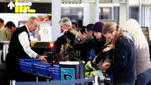 Passengers have their bags checked at Melbourne Airport.