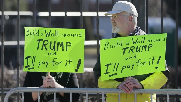 Two protesters stand outside on the University of Illinois-Chicago campus before a Trump rally that was called off on Friday because of security concerns.