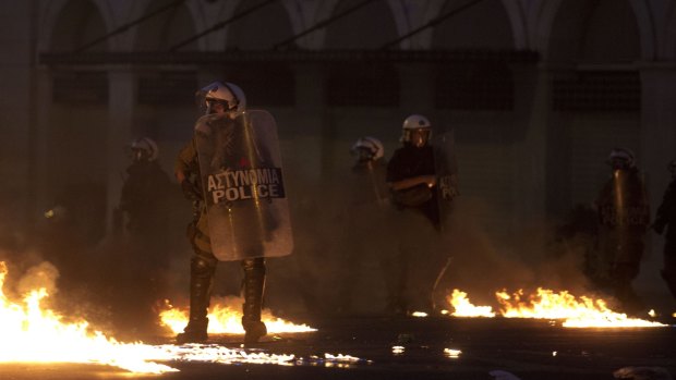 Riot police try to avoid petrol bombs thrown by anti-austerity protesters in Athens on Wednesday. 