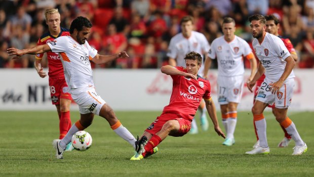 Jean Carlos Solorzano (left) of Brisbane Roar competes with Michael Marrone of Adelaide United during the A-League match in Adelaide on Friday.