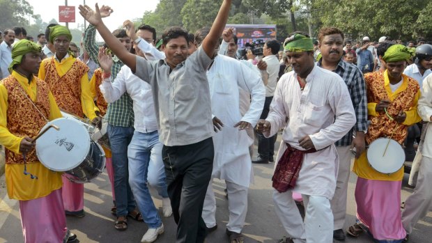 Supporters of an alliance of parties opposed to the ruling Bharatiya Janata Party celebrate in Patna, India, as early results of Bihar state elections indicate victory for them.