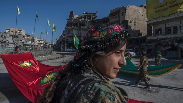 Fighters from the Kurdish  YPJ militia hold a celebration in Paradise Square in Raqqa. 