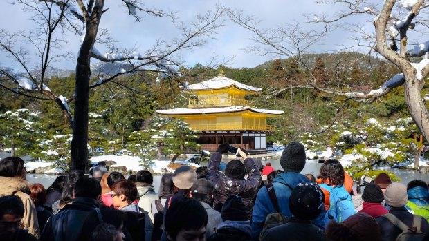 Tourists at Kinkakuji (Golden Temple) in Kyoto, Japan.