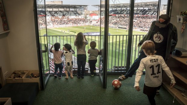 A kindergarten class watches preparations for a match from a classroom inside the FC St. Pauli soccer team's stadium in Hamburg, Germany.
