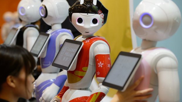 Humanoid robots stand in a row ahead of an exhibition held by SoftBank in Tokyo last year.