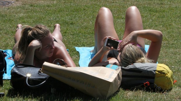 Two women sunbathe in Hyde Park in London on Tuesday as temperatures soared. 