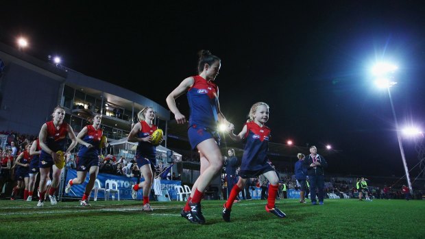 Daisy Pearce of the Demons leads the team out during this year's AFL women's exhibition match at Whitten Oval.
