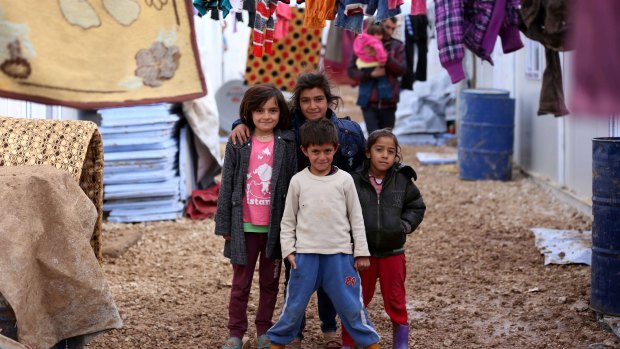 Displaced Iraqi children from the Yazidi community pose at Dawodiya camp for internally displaced people in the Kurdish city of Dohuk. 