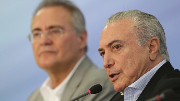 Brazilian President Michel Temer, right, talks about proposed anti-corruption legislation, flanked by Federal Senate President Renan Calheiros in Brasilia on Sunday.