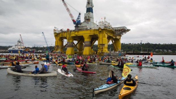 Activists in kayaks, who oppose Royal Dutch Shell's plans to drill for oil in the Arctic Ocean, approach Shell's Polar Pioneer drilling rig near the port of Seattle on Saturday.