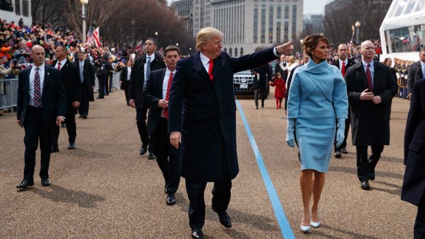 Donald Trump and first lady Melania Trump walk along the Inauguration Day parade route after he was sworn in as the 45th President of the United States.