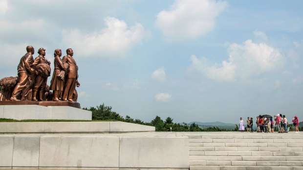 Foreign tourists visit a 'template' farm village in Pyongyang, North Korea.