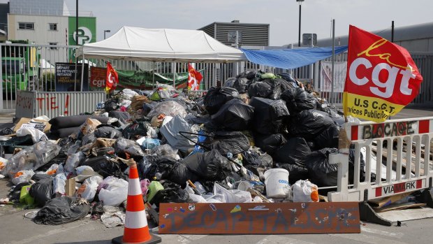 French striking CGT labour Union garbage collectors use rubbish to block access  to the waste treatment centre in Ivry Sur Seine, near Paris on Wednesday.