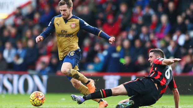 Aaron Ramsey is challenged by Bournemouth's Andrew Surman.