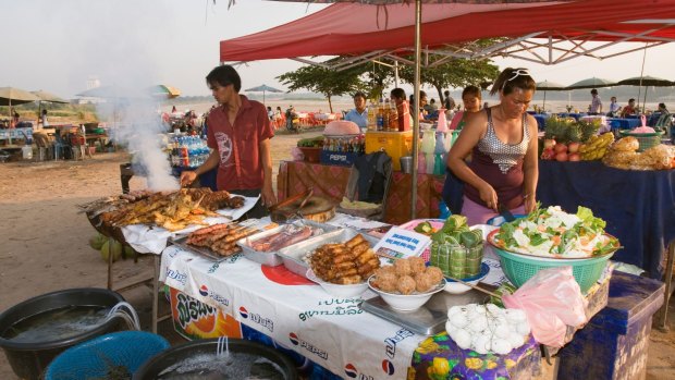 Food stalls on side of Mekong River, Vientiane, Laos.