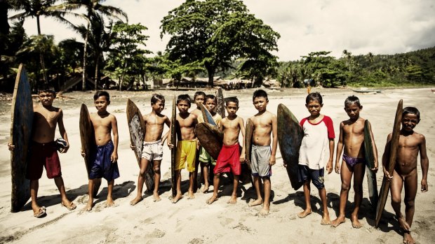 Child surfers on Morotai Island. One of Indonesia's northernmost islands, Morotai boasts a unique surfing culture.