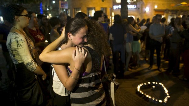 Teenagers comfort each other during a candlelight vigil in Jerusalem for Shira Banki.