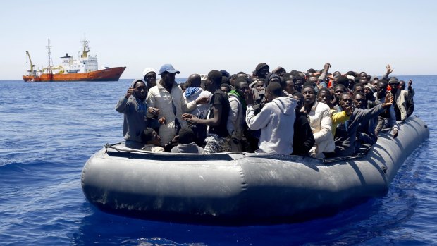 African migrants on a dinghy are approached by the Search and Rescue team of SOS Mediterranee during an operation in the Mediterranean sea on Monday when 253 migrants were rescued.