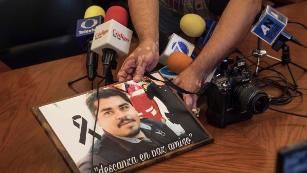 An image of slain Mexican journalist Edgar Daniel Esqueda Castro, in protest, before the start of a press conference about his death.