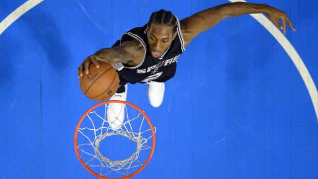 Bargain pick-up: Kawhi Leonard, the 15th pick of the 2011 draft, goes up for a slam for San Antonio.
