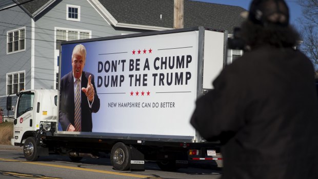 A truck with a sign against Donald Trump drives away outside a campaign stop by New Jersey Governor Chris Christie, who is also a 2016 Republican presidential candidate, in Manchester, New Hampshire, last week.