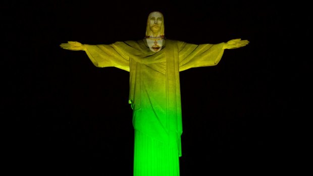 The Christ the Redeemer statue is lit in green and yellow to mark 100 days left to the Olympic Games in Rio de Janeiro, on April 27.