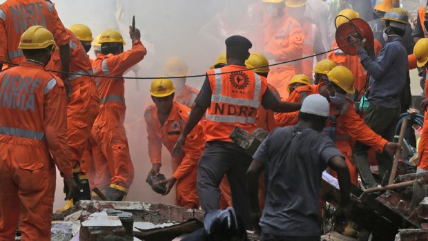 Rescuers work at the site of a building collapse in Mumbai, on Thursday.