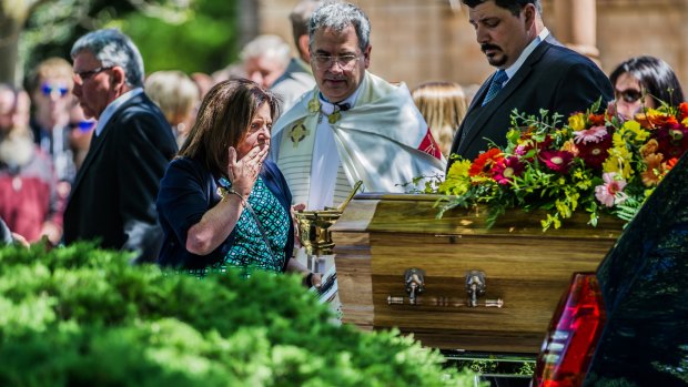 Kim Dorsett says her final goodbye at the funeral of her children Kate Goodchild and Luke Dorsett in Canberra last year.