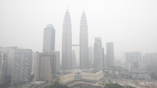 Malaysia's landmark Petronas Towers and other commercial buildings are seen shrouded with haze in the Malaysian capital, Kuala Lumpur.