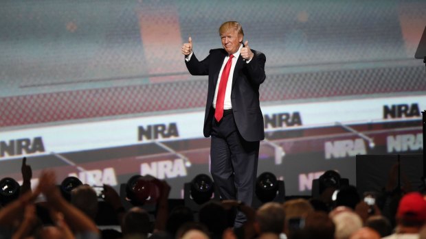 US President Donald Trump gestures after speaking at the National Rifle Association-ILA Leadership Forum in Atlanta. 