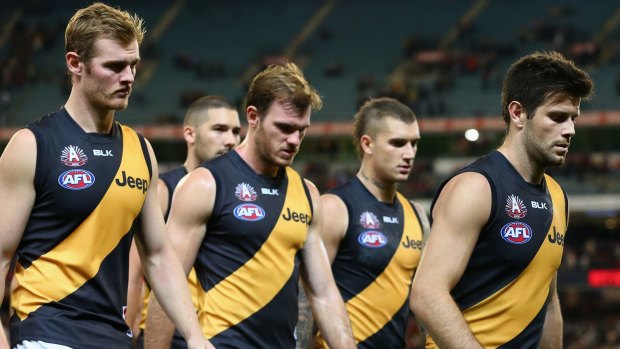 A dejected Trent Cotchin leads his team off the field after losing to Melbourne.