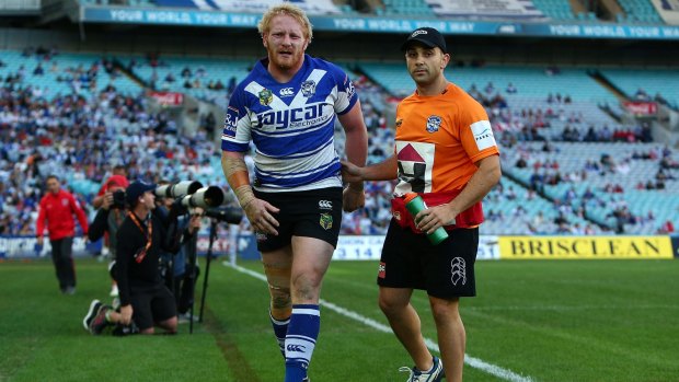 Hobbled: Bulldogs skipper James Graham leaves the field with a hamstring injury.