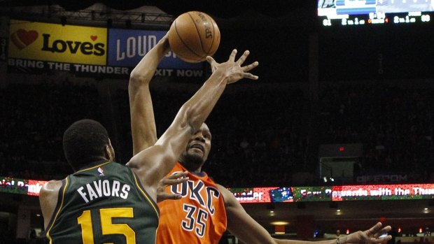 Favourable position: Oklahoma City Thunder forward Kevin Durant goes to the basket as Utah Jazz centre Derrick Favors defends. Oklahoma City won 104-98 in overtime. 