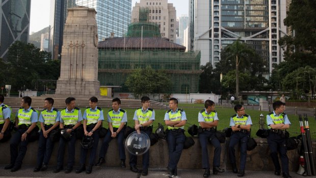 Presence: Police officers stand on Connaught Road Central in Hong Kong.