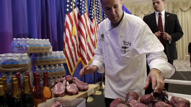 A chef with the Trump National Golf Club arranges Trump steaks before a news conference by Republican presidential candidate Donald Trump on Tuesday.