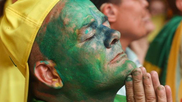 An anti-government demonstrator listens to the vote count, as lawmakers vote on whether or not to send the Rousseff impeachment process to the Senate.