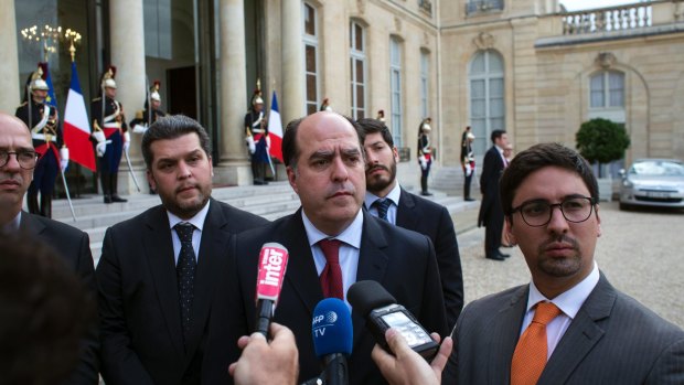 Venezuelans Julio Borges, centre, Freddy Guevara, right, and Eudoro Gonzalez, centre left, speak to the press after a meeting with Emmanuel Macron at Elysee Palace in Paris.
