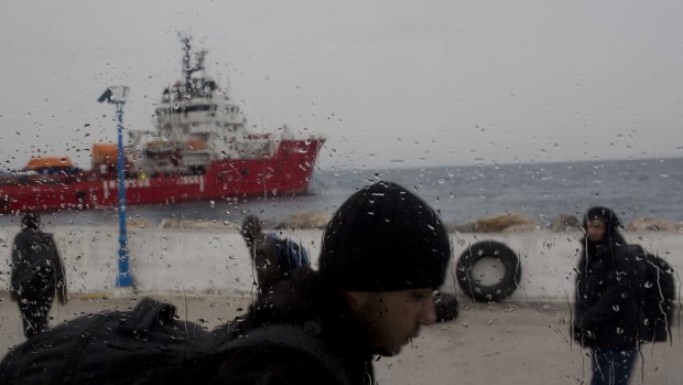 Syrian refugees disembark from a Greek coastguard boat near Lesbos on Wednesday.