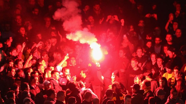A flare is set off during the match.