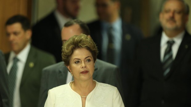 Brazillian President Dilma Rousseff arrives at a press conference after impeachment proceedings were opened against her.