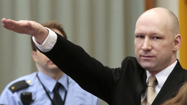 Norwegian mass killer Anders Behring Breivik gives the Nazi salute as he enters the courtroom.