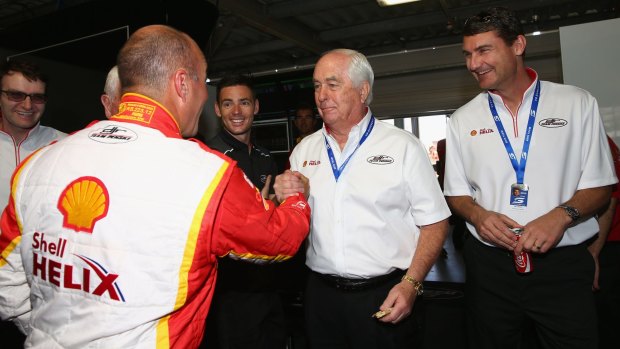 Quick solutions: Roger Penske (centre) made a flying visit to Perth to check on his V8 team. 