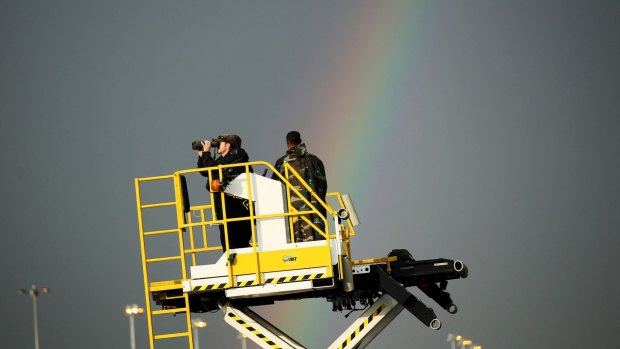 Security agents scan the horizon as Barack Obama arrives in Ethiopia aboard Air Force One.